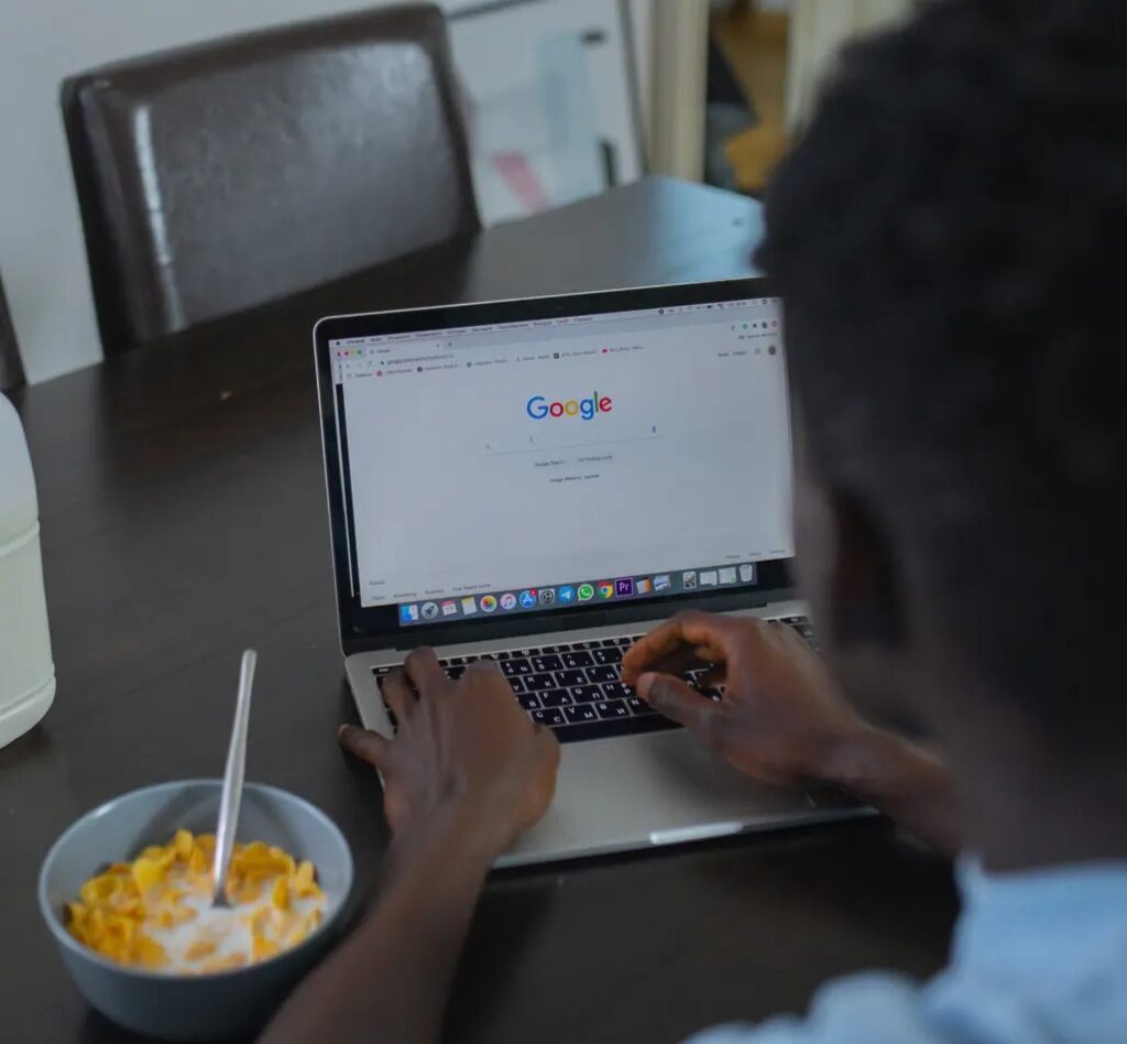 Man using google search on his laptop.